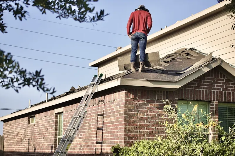 Professional roofer working on a residential roof in Raritan Gardens